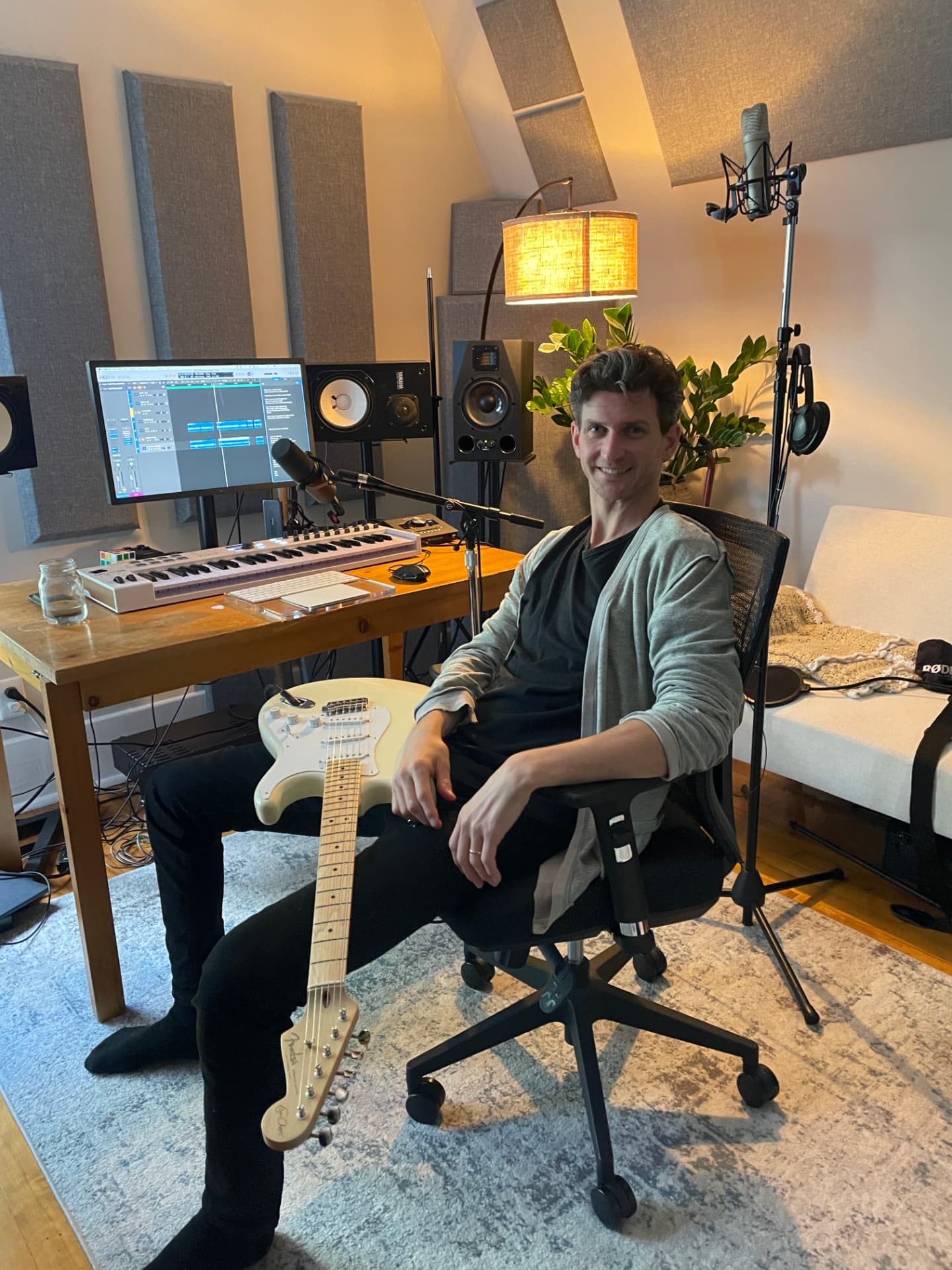 Charles in his Montreal studio with a guitar on his lap